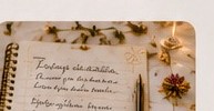 A journal with pressed flowers and a pen for reflection