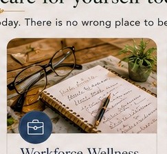 Glasses resting on an open journal, representing workforce wellness reflection